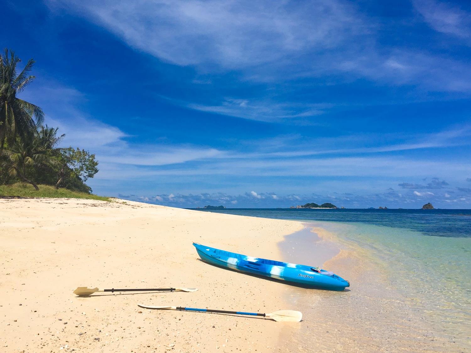 Things to do in Coron cover image of Kayak and paddles on island beach in north of Busuanga Island.