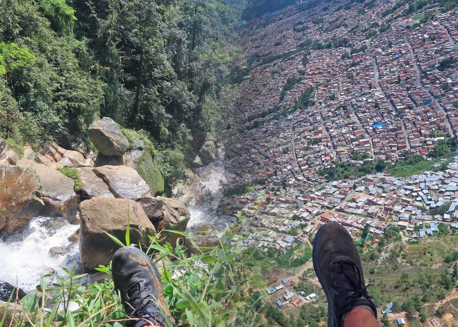 Split screen of feet by waterfall and feet while paragliding in Medellin