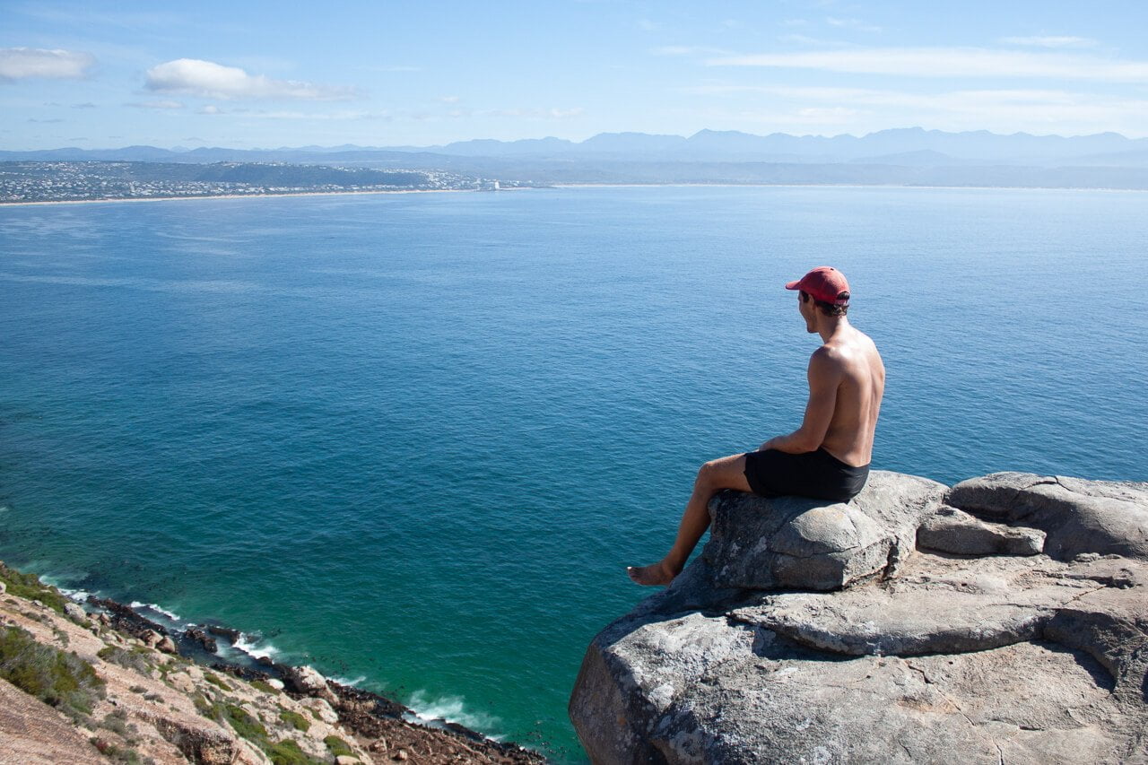 Garden Route travel guide cover image of Chris overlooking Plettenberg Bay from Robberg Peninsula.