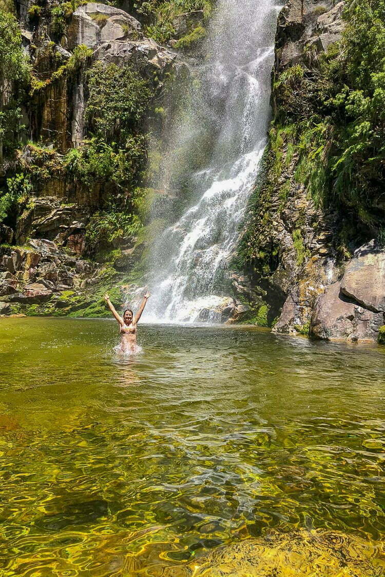 My friend Alex enjoying the escape into the wild underneath a waterfall